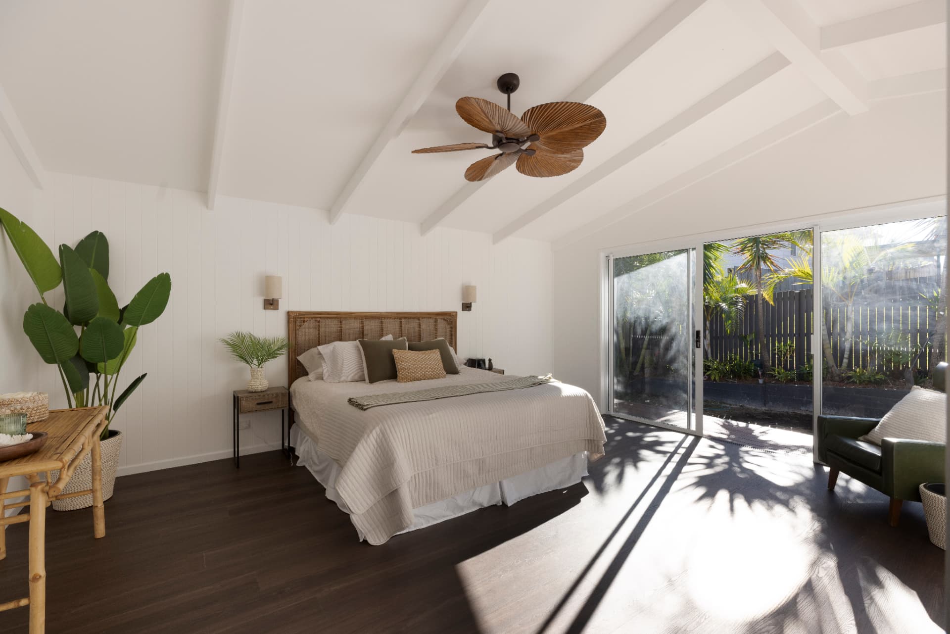 Master bedroom extension with raked ceiling and timber fan opening to a tropical deck.