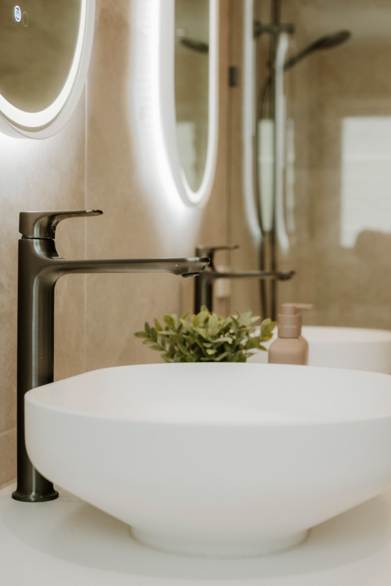 Mermaid Waters bathroom detail with vessel basin, gunmetal tapware and LED oval mirror.