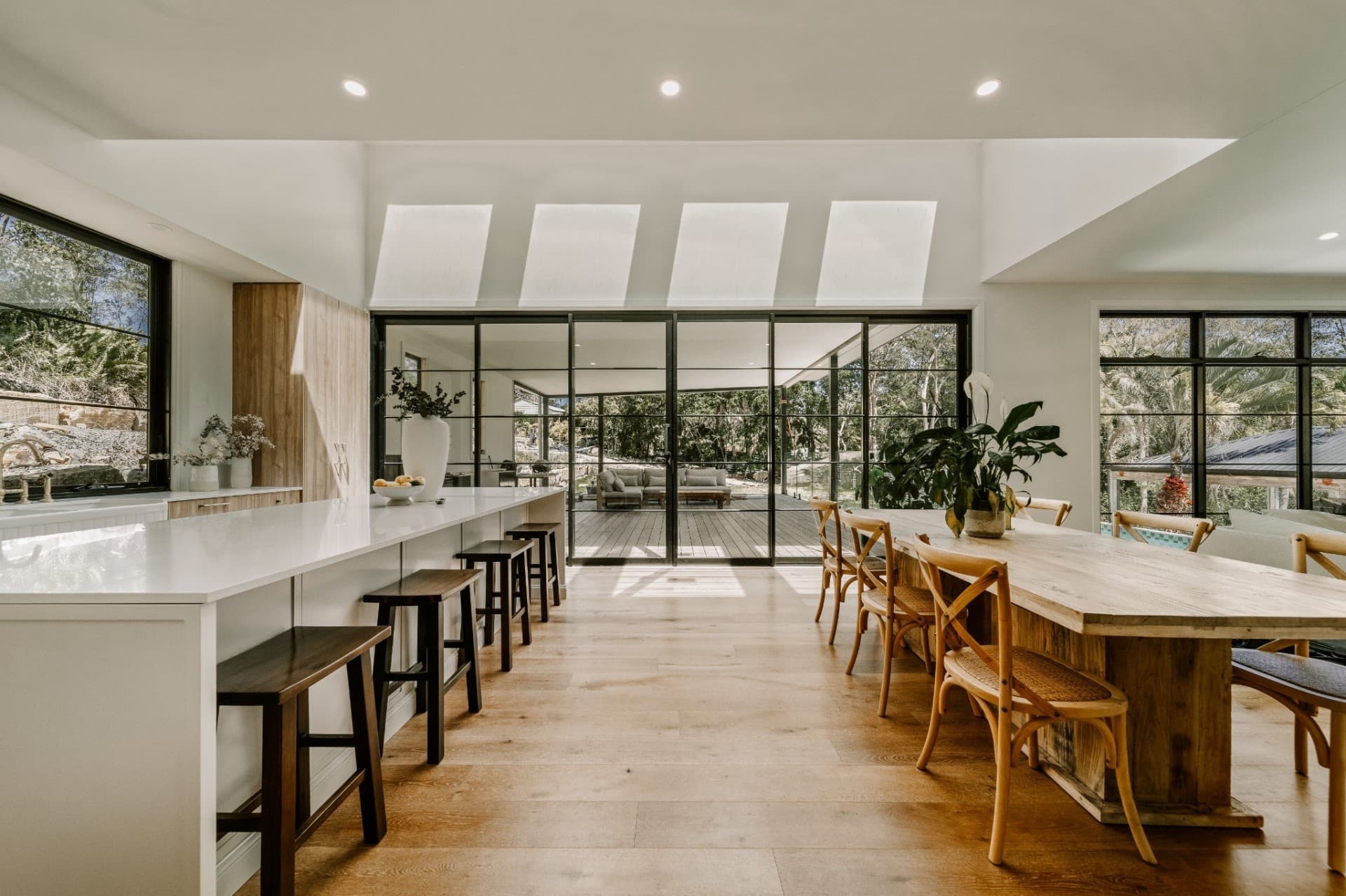 Yandala custom family home interior in Tallebudgera, open plan kitchen and dining opening to a deck and bushland.