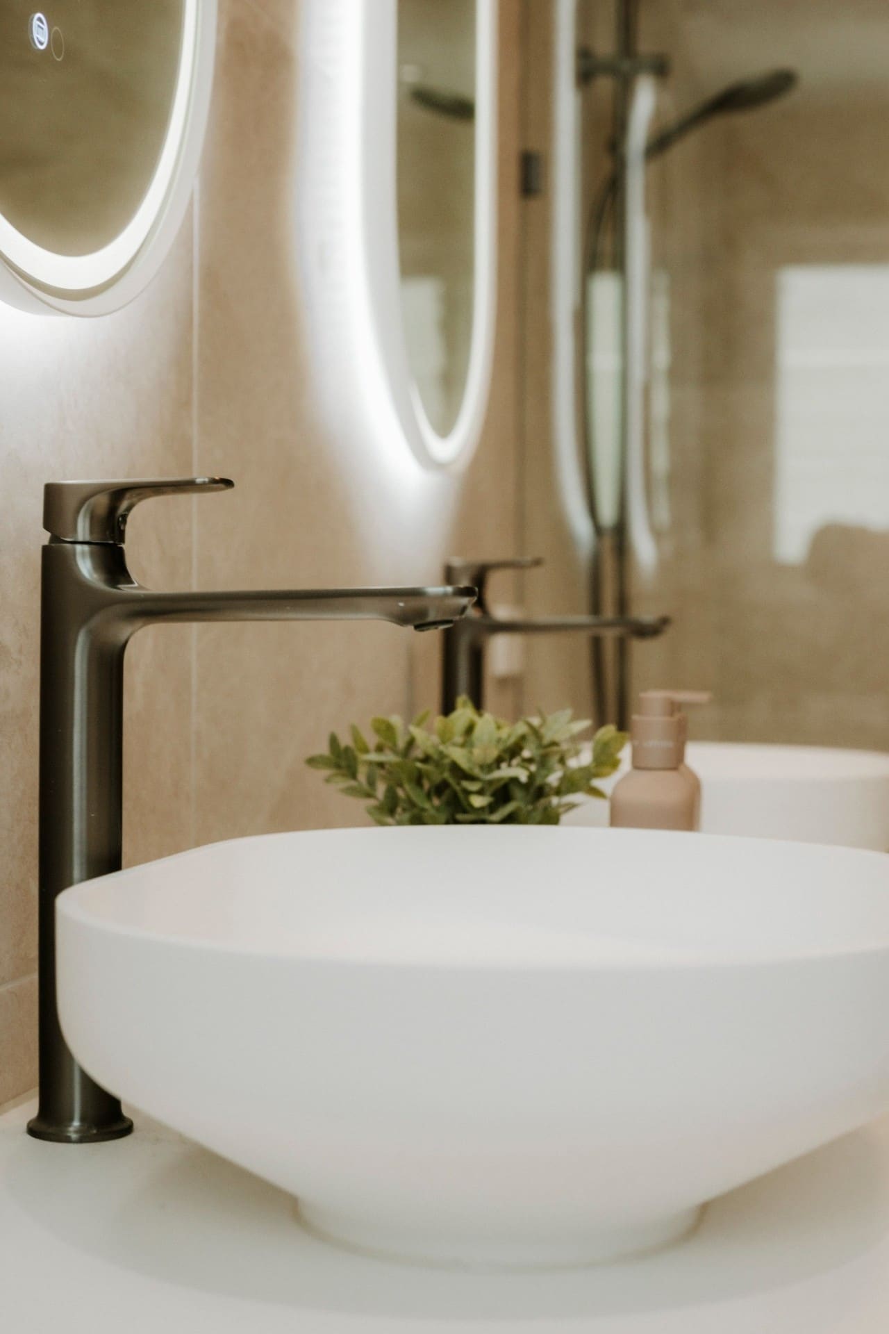 Mermaid Waters bathroom detail with vessel basin, gunmetal tapware and LED oval mirror.